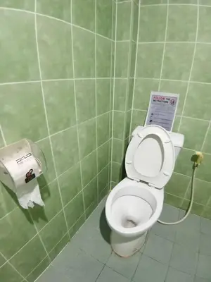 a bathroom with a toilet and a roll of toilet paper at Come see comsa in Koh Lone