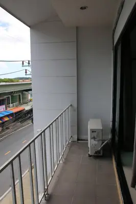 a balcony of a building with a train on the tracks at Come see comsa in Koh Lone