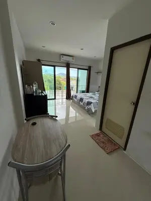 a room with a table and a bed and a bedroom at Come see comsa in Koh Lone