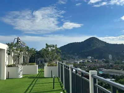 a balcony with a view of a city and mountains at Kamala Apartments in Kamala Beach