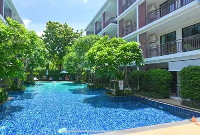 a swimming pool in front of a building at Rawai Title 3 in Rawai Beach