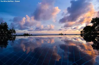 a swimming pool with a cloudy sky in the sky at Great view pool villas in Phuket