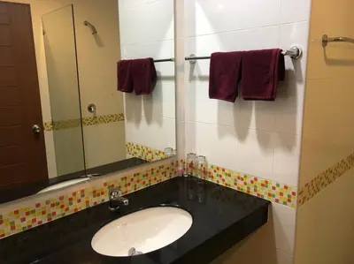 a bathroom with a sink and a mirror at Chollada inn kamala in Kamala Beach
