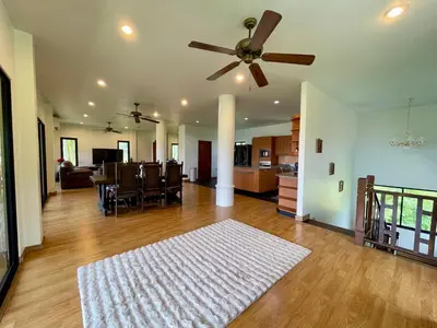 a living room with a ceiling fan and a dining room at Kata Sunset Bay Villa - 3BR Private Pool - Seaview in Kata Beach