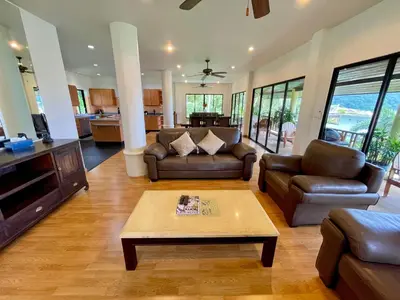 a living room with couches and a coffee table at Kata Sunset Bay Villa - 3BR Private Pool - Seaview in Kata Beach