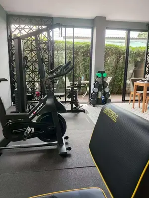 a gym with two treadmills and a treadmill at Antiya Hotel Phuket in Phuket Town