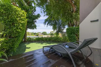 a pair of chairs sitting on a wooden deck at Antiya Hotel Phuket in Phuket Town