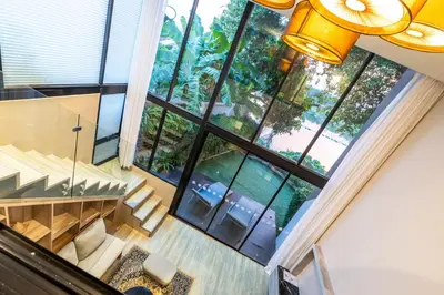 an overhead view of a living room with large windows at Antiya Hotel Phuket in Phuket Town