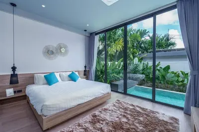 a bedroom with a bed and a large window at Stylish 2BR Naiton Aileen Villa w Private Pool in Nai Thon Beach