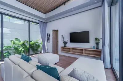 a living room with a white couch and a flat screen tv at Stylish 2BR Naiton Aileen Villa w Private Pool in Nai Thon Beach