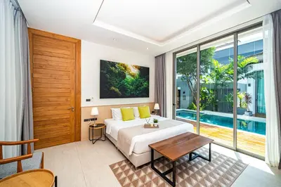 a bedroom with a bed and a pool at Teak 5 BR Pool Villa Bang Tao Airport Shuttle in Laguna Phuket