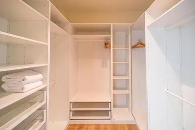 a walk in closet with white shelves at Teak 5 BR Pool Villa Bang Tao Airport Shuttle in Laguna Phuket