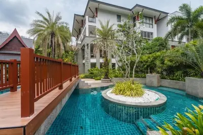 a swimming pool in front of a building at Elegant Beachfront 3BR Condo at Pearl of Naithon in Nai Thon Beach