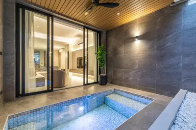 a swimming pool in the middle of a house at P Villas Patong in Patong Beach
