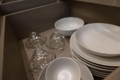 two stacks of plates and bowls in a cabinet at P Villas Patong in Patong Beach
