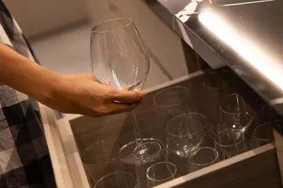 a person holding up a wine glass in an oven at P Villas Patong in Patong Beach