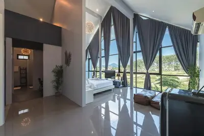 a large living room with a couch and large windows at V188 The Granary Loft Haven 3BR Pool Sanctuary in Bang Tao Beach