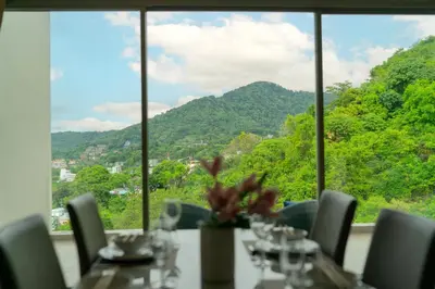 a table with chairs and a view of a mountain at Breathtaking Sea & Mountain View Private Pool in Karon Beach