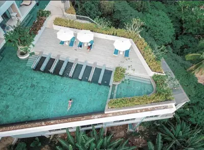 an overhead view of a swimming pool with umbrellas at Breathtaking Sea & Mountain View Private Pool in Karon Beach