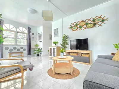a living room with a couch and a tv at Village Beach House I in Patong Beach