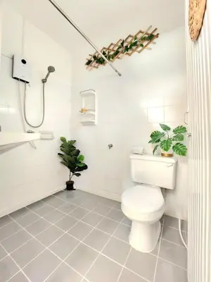 a bathroom with a toilet and plants in it at Village Beach House I in Patong Beach