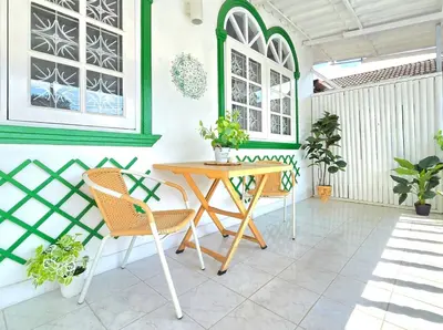 a patio with a wooden table and chairs at Village Beach House I in Patong Beach