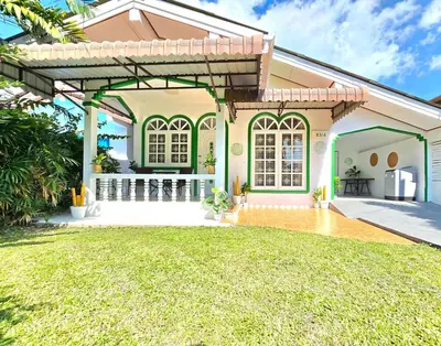 a home with a pergola and a yard at Village Beach House II in Patong Beach