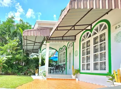 a house with an awning and a patio at Village Beach House II in Patong Beach