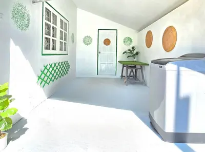 a white hallway with a white door and a table at Village Beach House II in Patong Beach