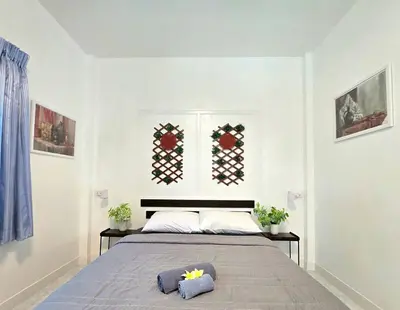 a bedroom with a bed with two pillows on it at Village Beach House III in Patong Beach