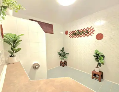a bathroom with two potted plants and a shower at Village Beach House III in Patong Beach