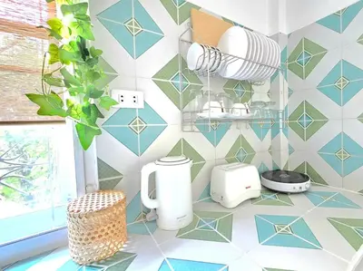 a bathroom with blue and white tiles on the wall at Village Beach House IV in Patong Beach