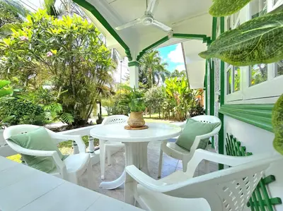 a white table and chairs on a patio at Village Beach House IV in Patong Beach