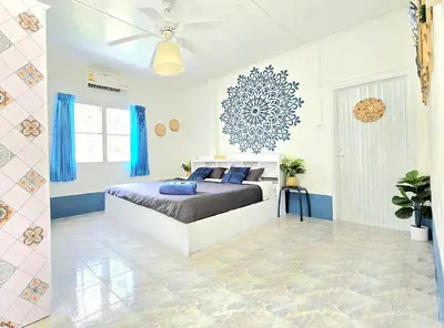 a bedroom with a bed and a ceiling fan at Village Beach House IV in Patong Beach