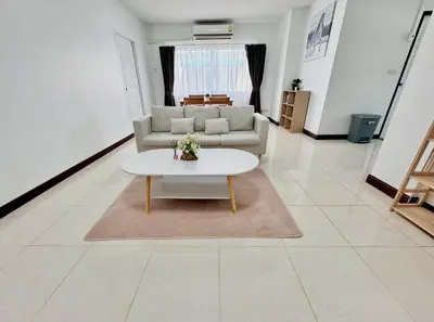 a living room with a couch and a table at TONY Central Stay in Phuket Town