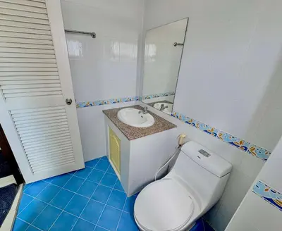 a bathroom with a white toilet and a sink at TONY Central Stay in Phuket Town