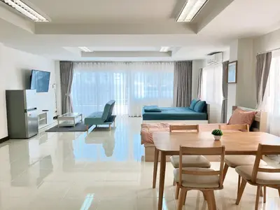 a living room with a table and a couch at TONY Central Stay in Phuket Town