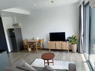 a living room with a television and a table at \u8d85\u4fbf\u5229 199\u53f7\u82ad\u4e1c\u6d77\u6ee9\u7cbe\u88c5\u516c\u5bd3 5\u5206\u949f\u5230\u6d77\u6ee910\u5206\u949f\u5230\u9152\u5427\u8857 in Patong Beach