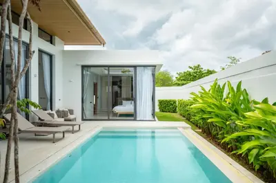 a swimming pool in the backyard of a house at Mouana Residence Song Khun Chalong VIP4-bedroom Pool Villa 89-14 in Chalong