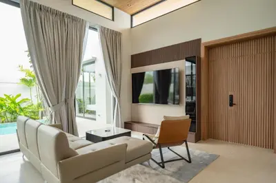 a living room with a white couch and a chair at Mouana Residence Song Khun Chalong VIP4-bedroom Pool Villa 89-14 in Chalong
