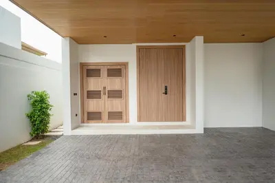 a wooden door on the side of a house at Mouana Residence Song Khun Chalong VIP4-bedroom Pool Villa 89-14 in Chalong