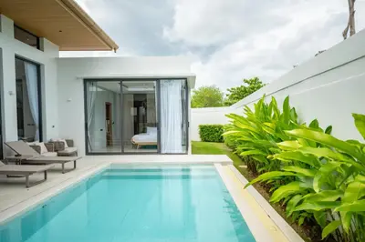 a swimming pool in the backyard of a house at Mouana Residence Song Khun Chalong VIP4-bedroom Pool Villa 89-14 in Chalong
