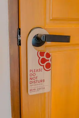 a sign on a door that says please do not disturb at Baan Cocoa Boutique Hotel in Natai Beach