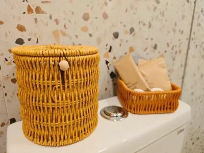 two baskets sitting on top of a toilet tank at Baan Cocoa Boutique Hotel in Natai Beach