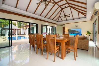 a dining room with a wooden table and chairs at Balinese-Style 3Bedrooms Villa Tina in Kata Beach