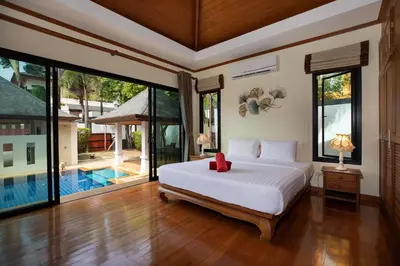 a bedroom with a bed and a swimming pool at Balinese-Style 3Bedrooms Villa Tina in Kata Beach