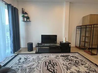 a living room with a tv and a rug at Anda Mantham Hill in Ban Bang Rong