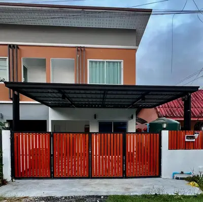 a house with a red gate and a red fence at Anda Mantham Hill in Ban Bang Rong