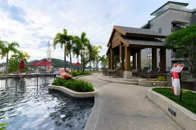 a resort with a swimming pool and a building at Mida Grande Resort 1106 by Phuket Sabay Rent in Surin Beach