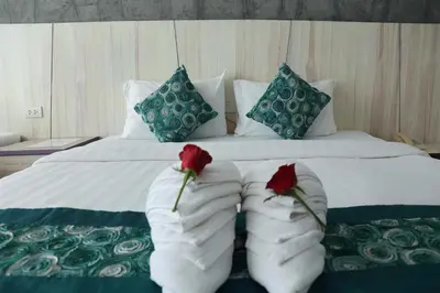 a bedroom with a bed with two roses on it at Bellevue Ocean Patong in Patong Beach